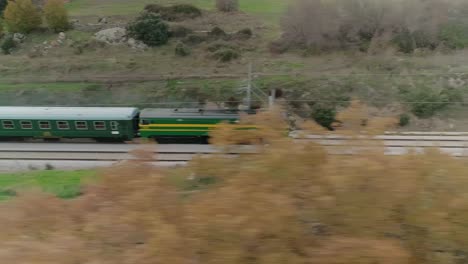 aerial tracking sideways shot of the philip ii train going along the tracks