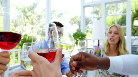 group of friends toasting glasses of wine