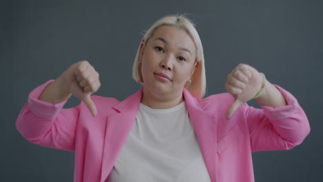 Woman in Pink Blazer with Disapproving Expression