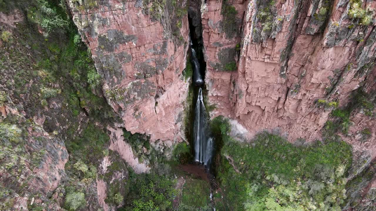 Aerial tilt down of Perolniyoc waterfalls in Sacred Valley Cuzco, Peru a famous hiking spot during summer