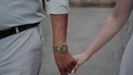 couple holding hands in slow motion, symbolizing unity and love - slow motion