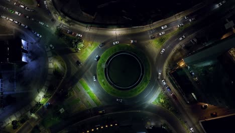 top-down nighttime shot of cars driving through a roundabout in iquique, chile