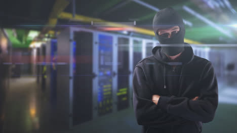 caucasian male wearing a hood in a data room looking at the camera