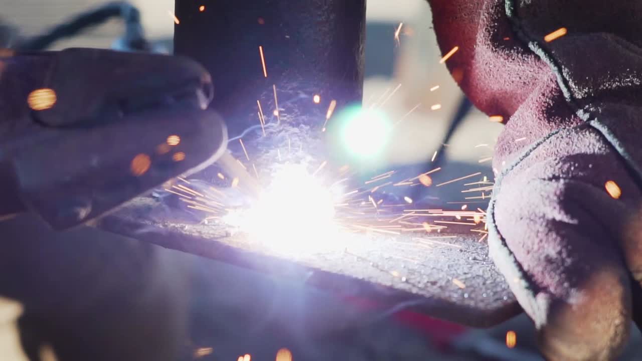 Macro Shot Of Fire Sparkling From A Welding Rod Used By A Blacksmith - close up