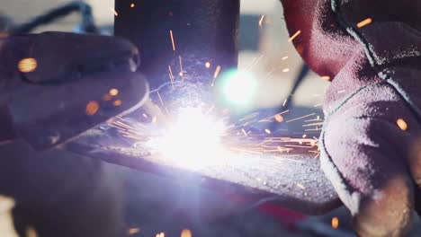 macro shot of fire sparkling from a welding rod used by a blacksmith - close up