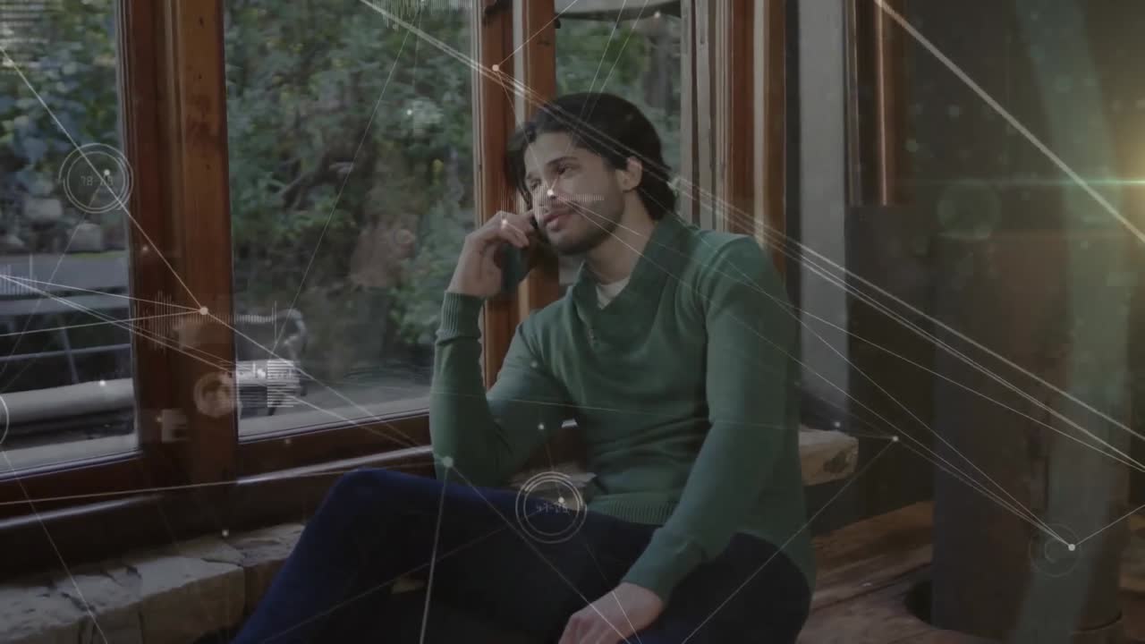 Animation of network of conncetions with data processing over biracial man talking on smartphone