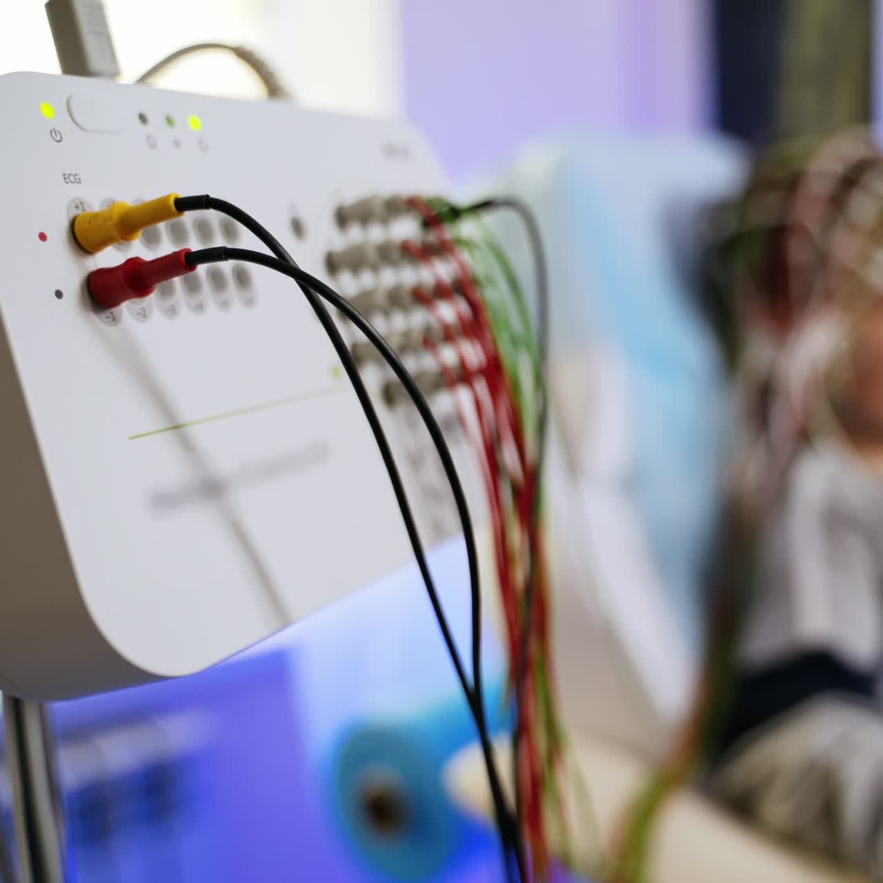 Sensor board for brain examination. Close up. Boy undergoing check up at backdrop in blur