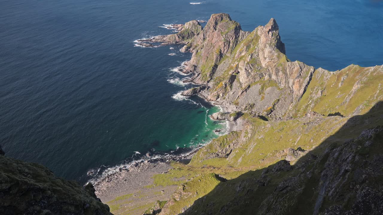Stunning aerial view of rugged coastal cliffs and the deep blue sea in Måtinden Vestarelen, Norway