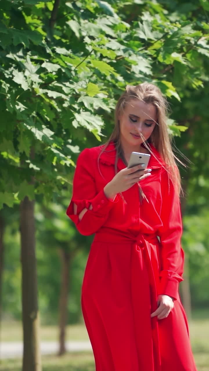 Woman using smart phone in the city. Young woman with smartphone in urban city area. Vertical video