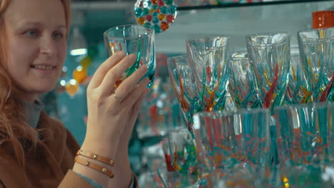 young woman looking at venetian glass in the store