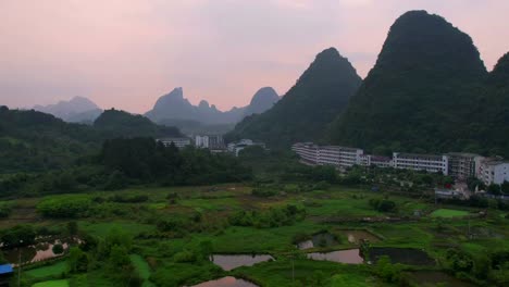 Aerial-hyperlapse-towards-Yangshuo-karst-mountains-at-sunset,-China