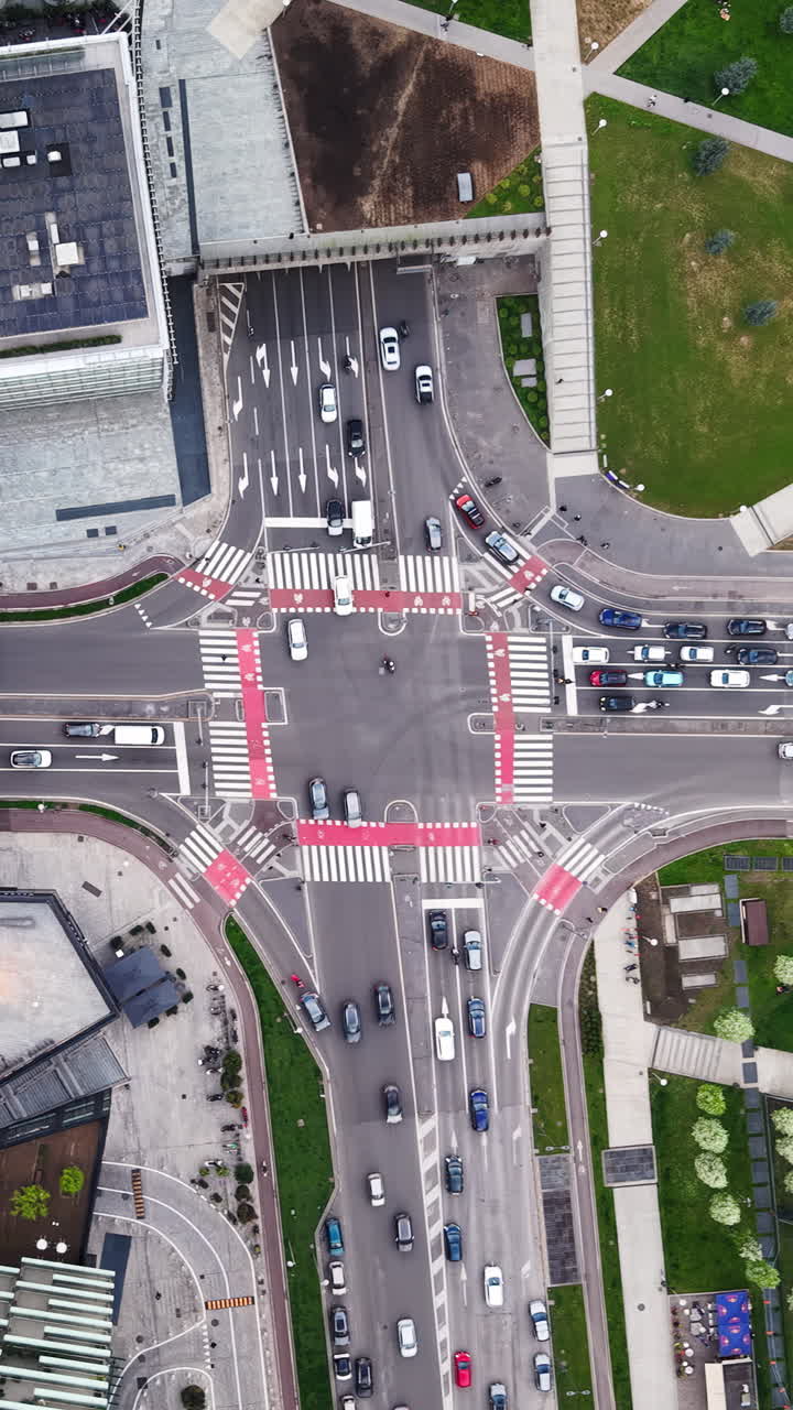Aerial drone view of cars moving in traffic in Milan, Italy in daylight. Vertical