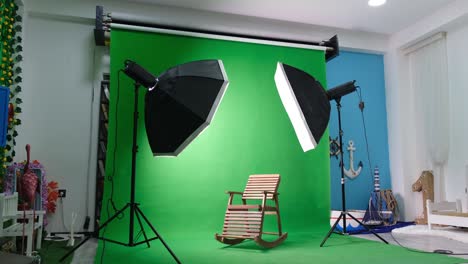 photo or video studio with two hexagone studio lights. green screen and fixed chair