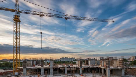 construction progress at sunset: a tower crane overseeing the development of a new building project with dynamic skies and a growing cityscape