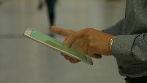 cropped hand of man using digital tablet