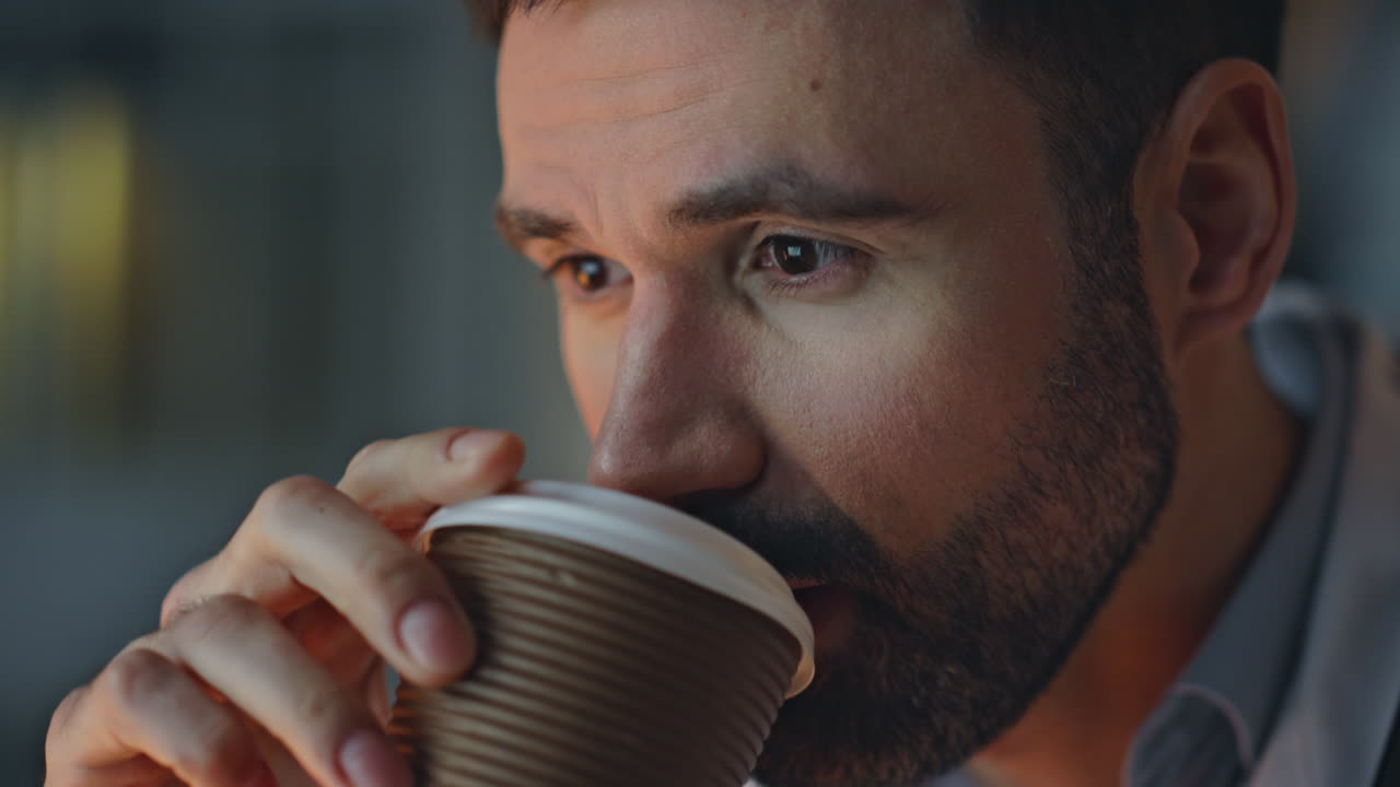 Serious doctor drinking coffee in hospital closeup. Healthcare worker take break