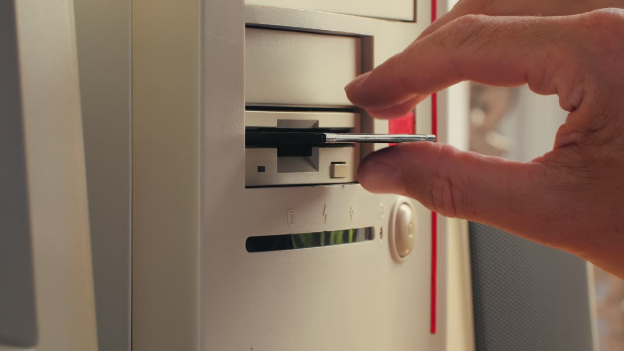 Using diskette for old computer. Music recorder, playing retro computer games. Vintage device for office, obsolete technology. . High quality 4k footage