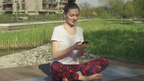 young woman listening music on headphones