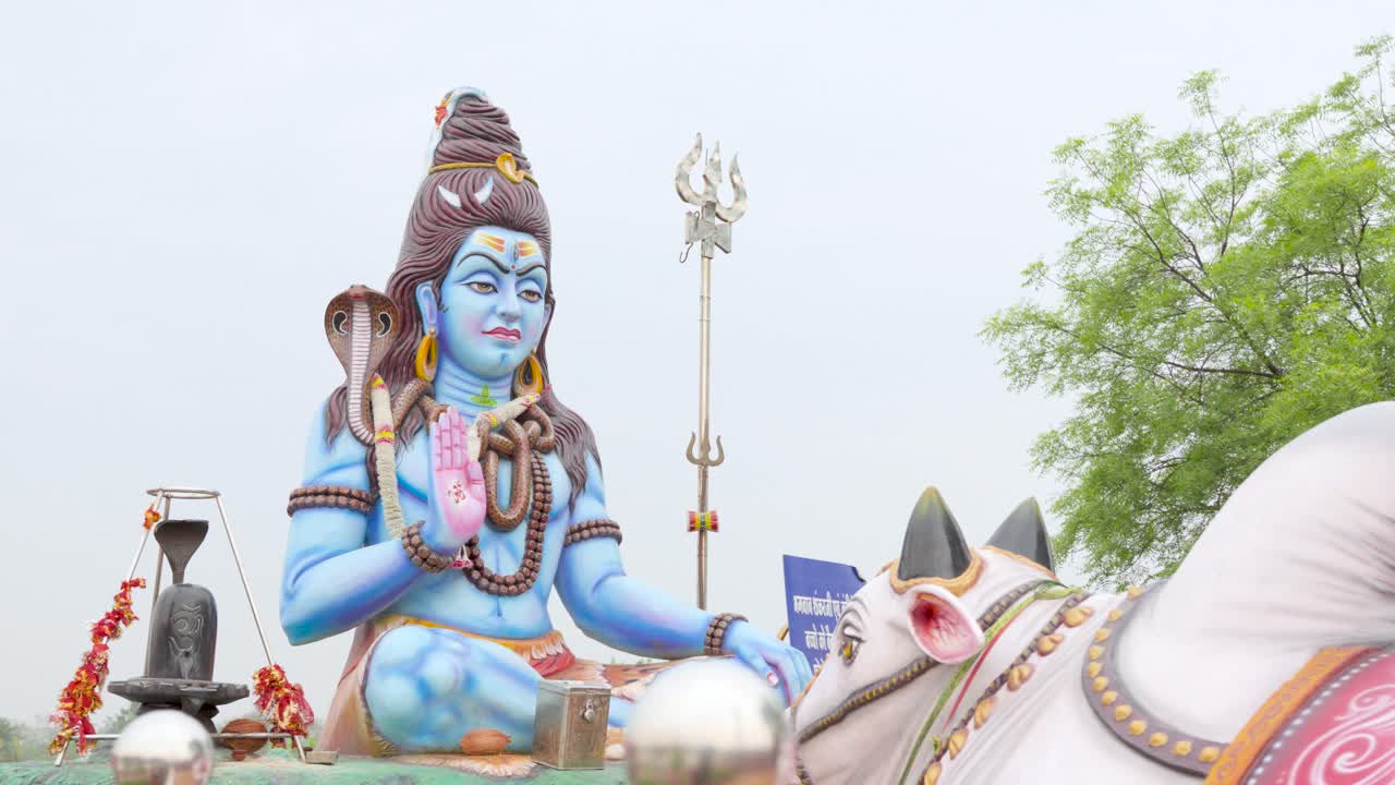 Slider shot of a statue of the Hindu deity Shiva, highlighting spiritual symbolism, religious devotion, and traditional sculpture associated with Indian culture and faith