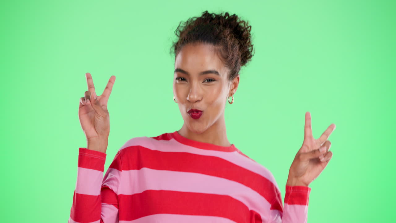 A cheerful woman making a peace sign