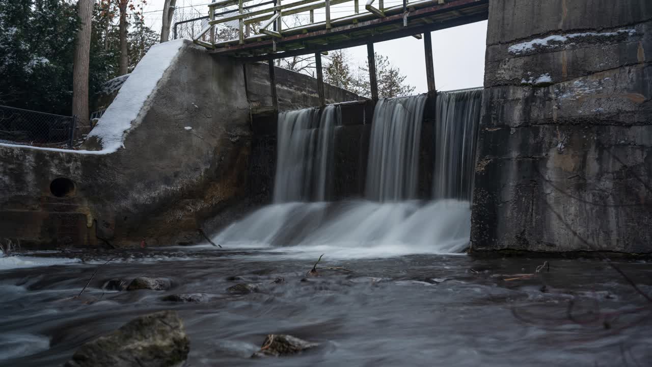 Timelapse of Alton Mill dam sluice river waterfall in winter, Canada