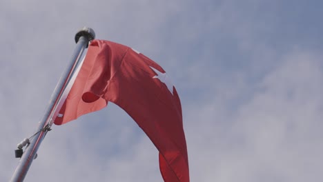 turkish flag waving on bright blue sky background. action. bottom view of a red turkish swaying in the wind