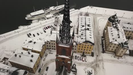 establishing aerial view of beautiful riddarholmen and neighbouring port in stockholm city centre during wonderful winters day