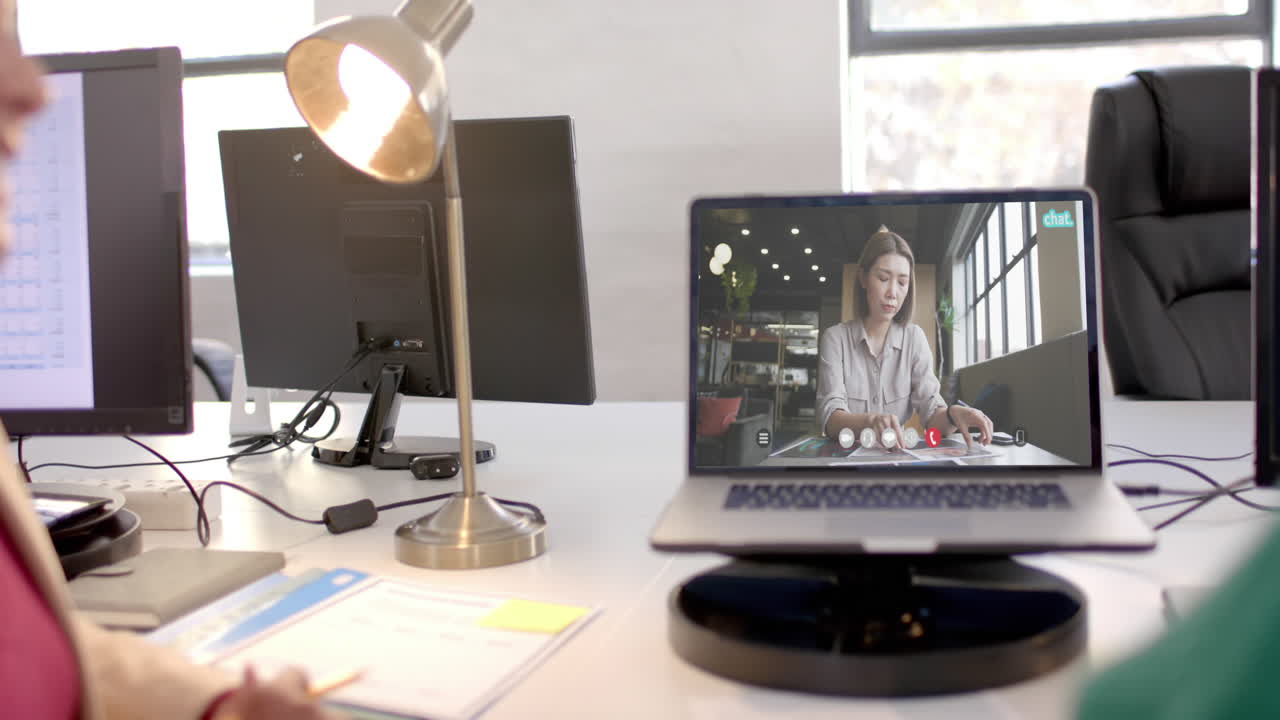 Laptop with video call with caucasian businesswoman on screen