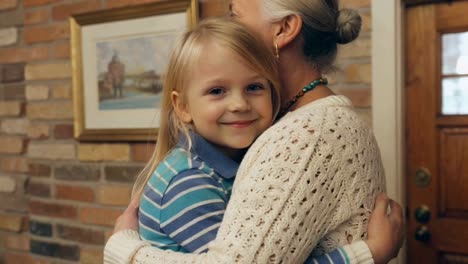 happy grandchild joyfully hugging loving grandmother at home
