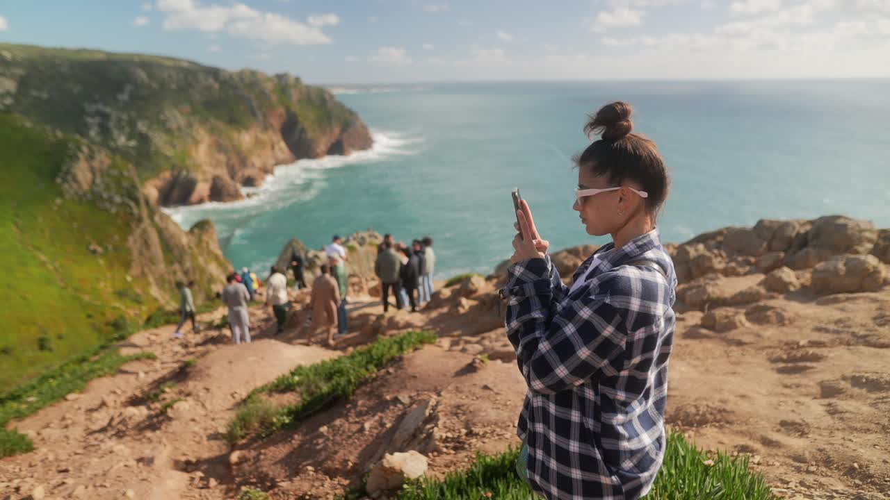 Woman Taking Photo of Coastal Landscape