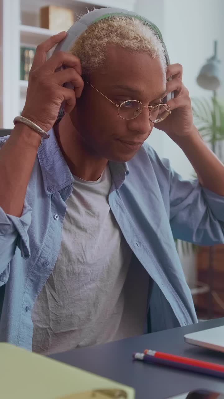 Focused young man working on computer in cozy indoor setting