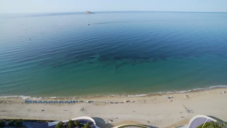 Wide-angle-Mediterranean-beach,-resorts-and-island-from-above,-Benidorm-4K