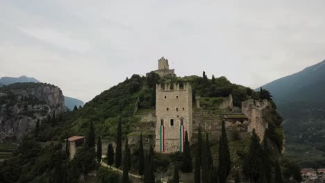 Drone-shot-looking-over-Castello-di-Arco-into-Valle-del-Sarca-in-Trentino-Italy