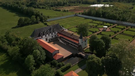 aerial shot revealing the batie d'urfé castle and the forez plain landscape on a sunny day of spring, loire departement, auvergne rhone alpes region, france