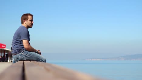 Lonely-Man-Looks-At-Ocean-With-Texhold