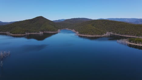 stunning landscape from hinze dam - advancetown lake and forested mountain - gold coast, qld, australia