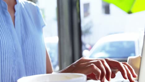 Smiling-businesswoman-using-laptop