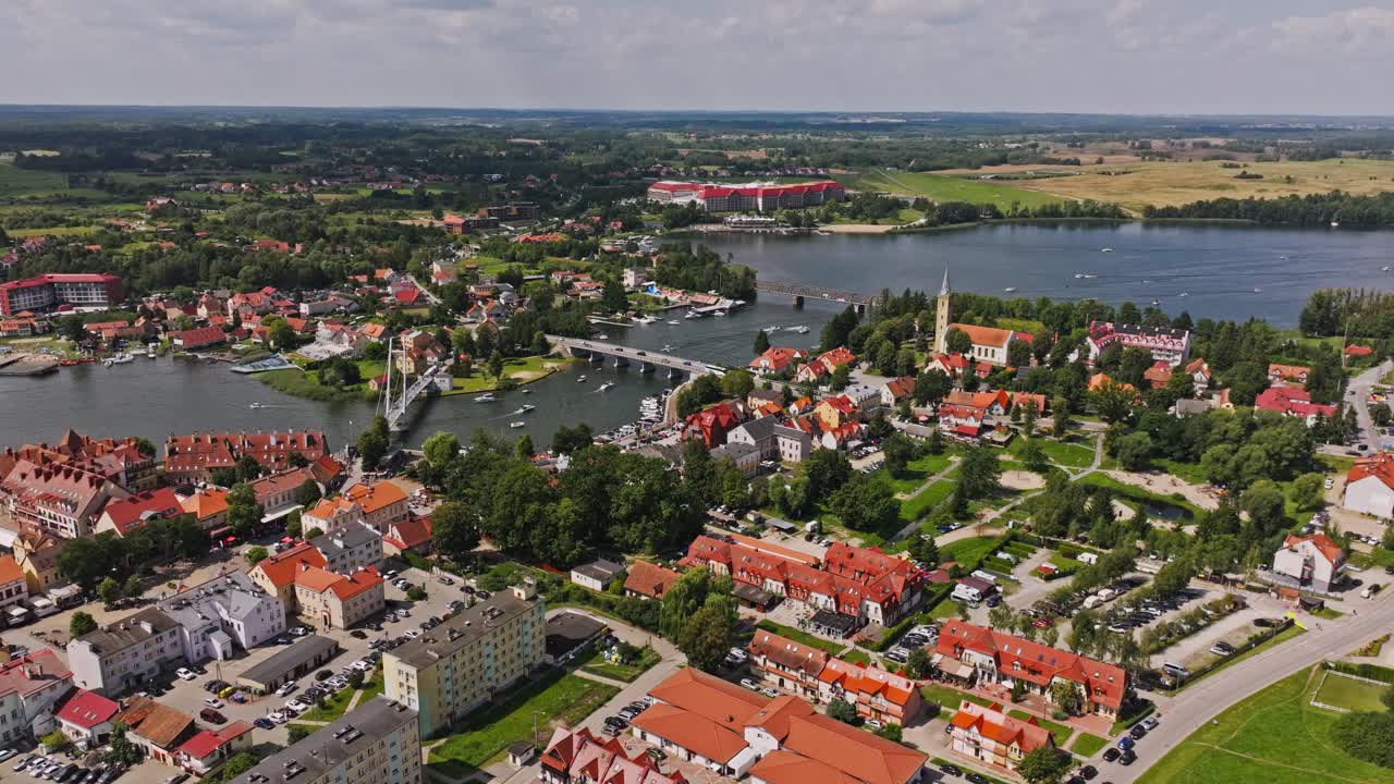 Aerial establishing shot of Mikolajki showing lake bridges and cultural heritage
