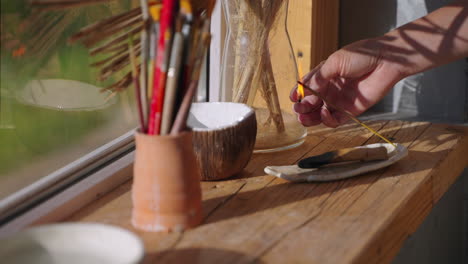 woman lighting incense in an artist's studio