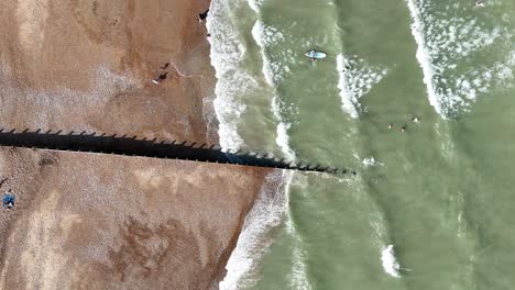 overhead birds eye drone aerial view shingle beach eastbourne sussex uk