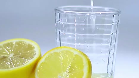 slice lemon fruit juice in glass of water on table with white background no people stock footage stock video