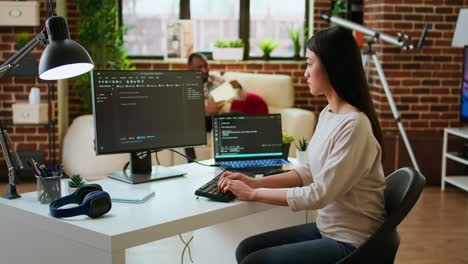 asian female developer coding cloud computing applications on pc