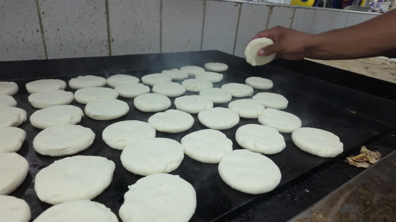 Hot arepas cooking on a grill, delicious and inviting scene