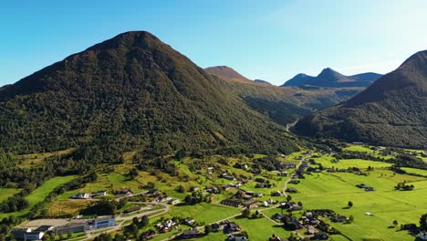 aerial over the valleys and fields near syvde towards sunset, vanylven municipality, norway