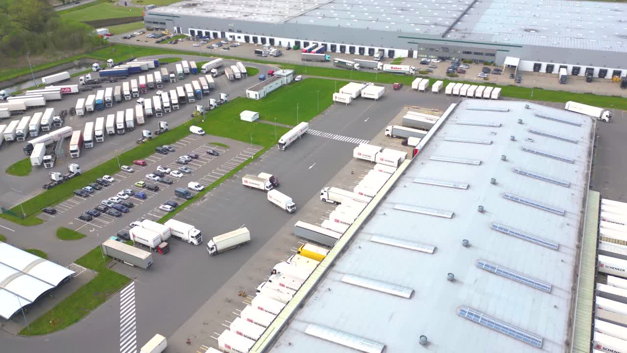 Time lapse Aerial drone view of group of large modern industrial warehouse or factory buildings in suburban city area