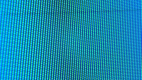 pixels of an old analog tv screen close up. the blue and green dots create a moving arrow on the display. macro. close up