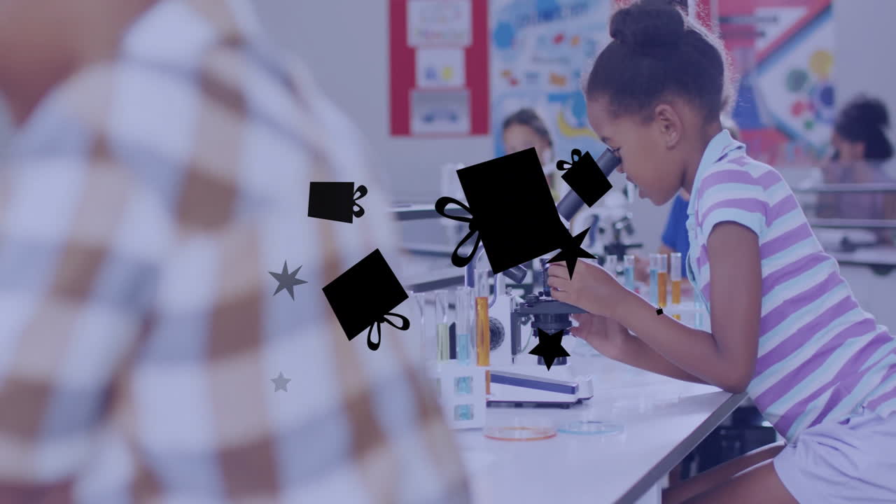 In school, child using microscope with animation of gift icons overlaying