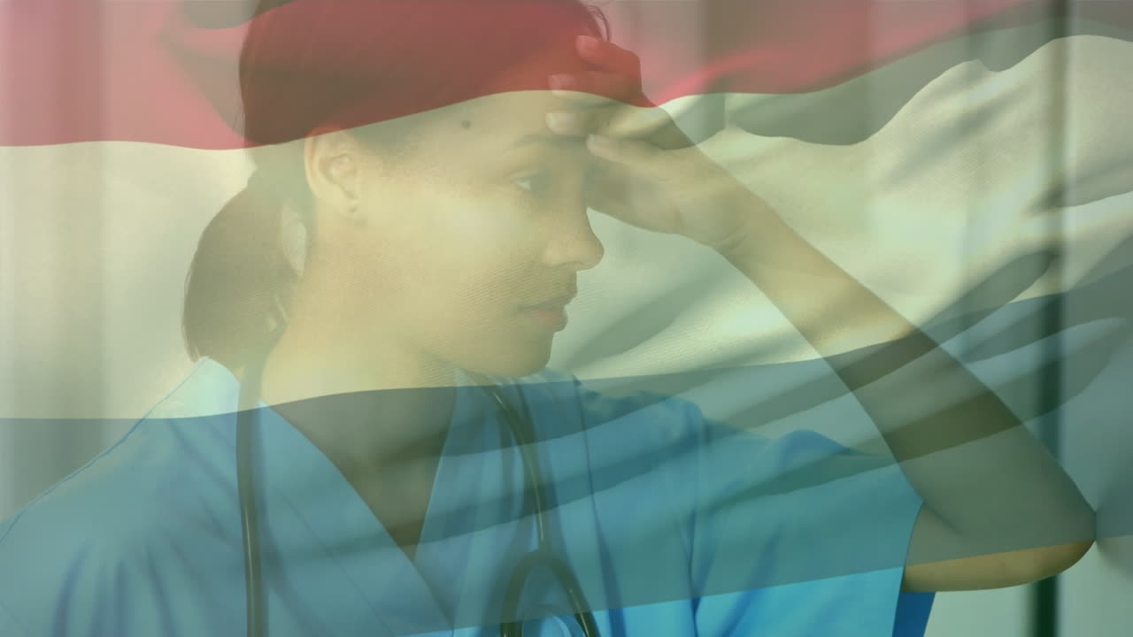 네덜란드 국기 애니메이션이 두 인종의 여성 의사 위에