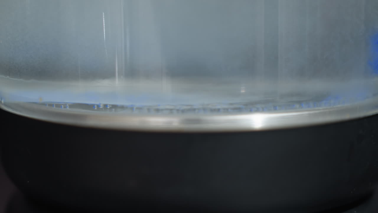 CloseUp Glass Vessel Rim With Microbubble Layer And Gentle Aeration, Clear Liquid Wash In Clinical Testing Environment, Precision Cleaning And Ultrasonic Circulation For Device Validation