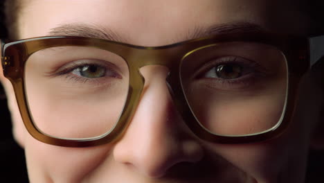 Macro-of-smiling-young-woman-wearing-glasses-indoors.Businesswoman.